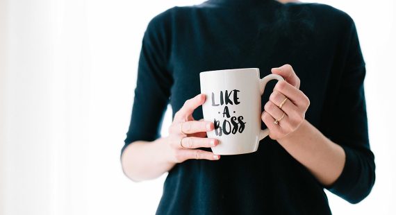 content creator holding a mug with the words like a boss